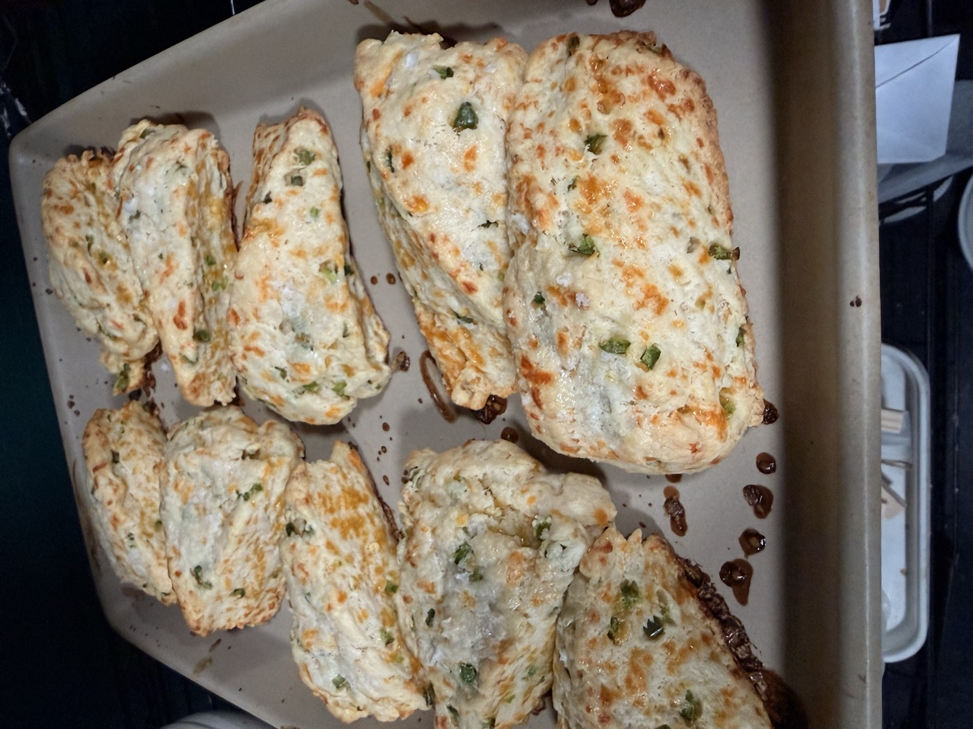 Tray of cheddar jalape&ntilde;o scones baked golden and studded with peppers