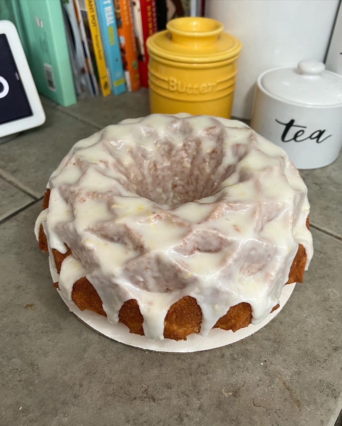 Lemon bundt cake under a thick pour of lemon icing