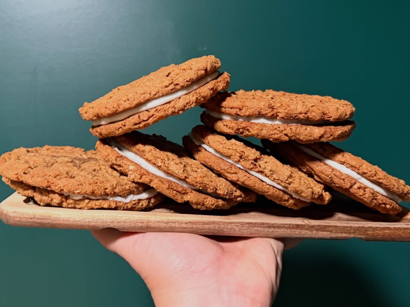 Stack of oatmeal cream pies on a wooden board