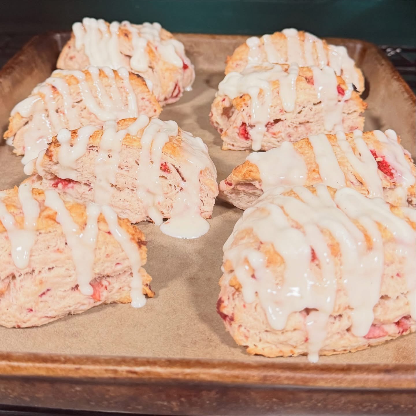 Strawberries and cream scones with warm vanilla glaze